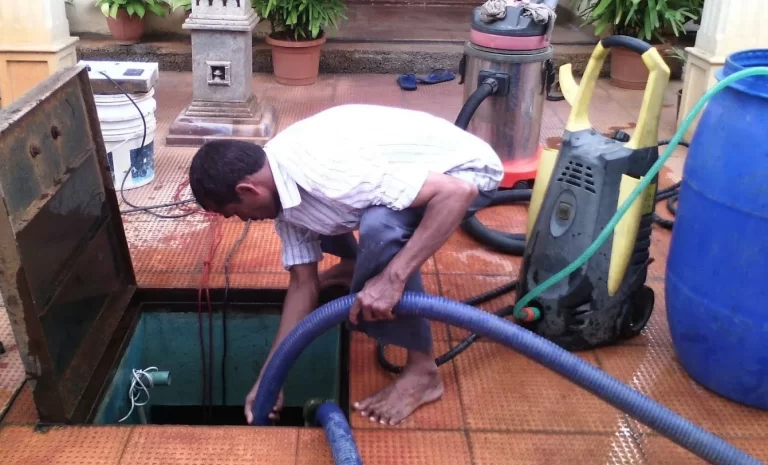 A. R. M. Solutions technician vacuum-cleaning an underground water tank