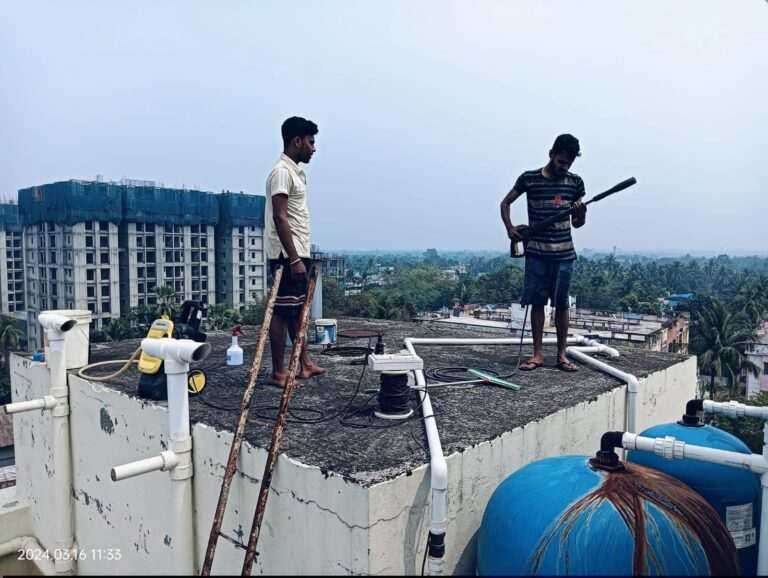 A. R. M. Solutions technicians cleaning a rooftop water tank